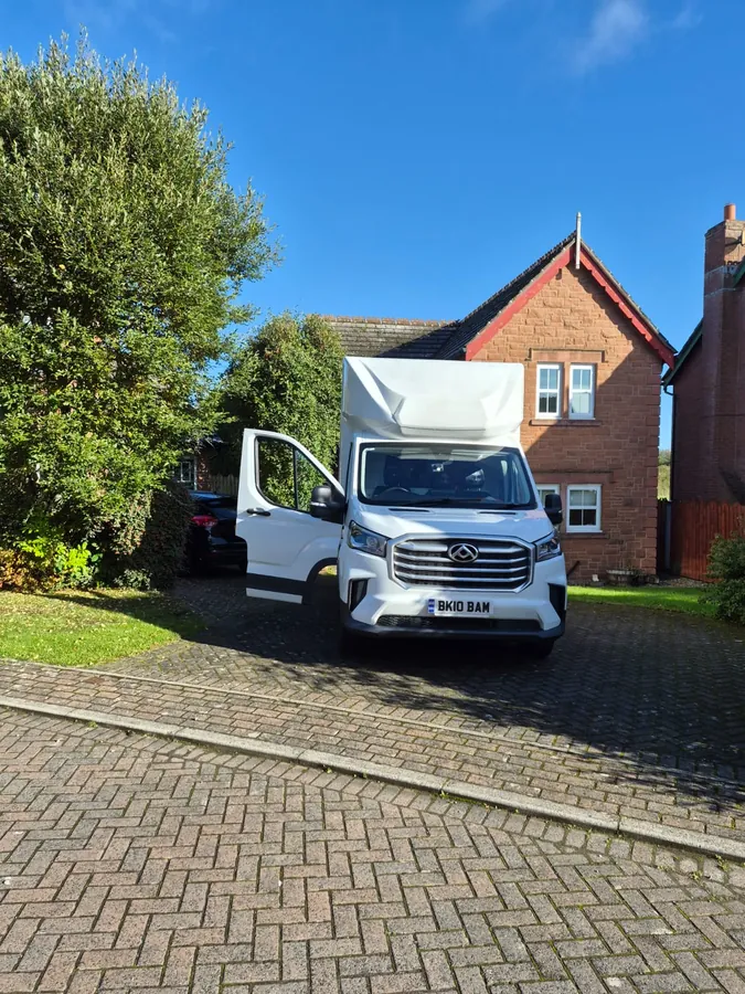 The Luton van on a driveway with the cab door open, ready to load